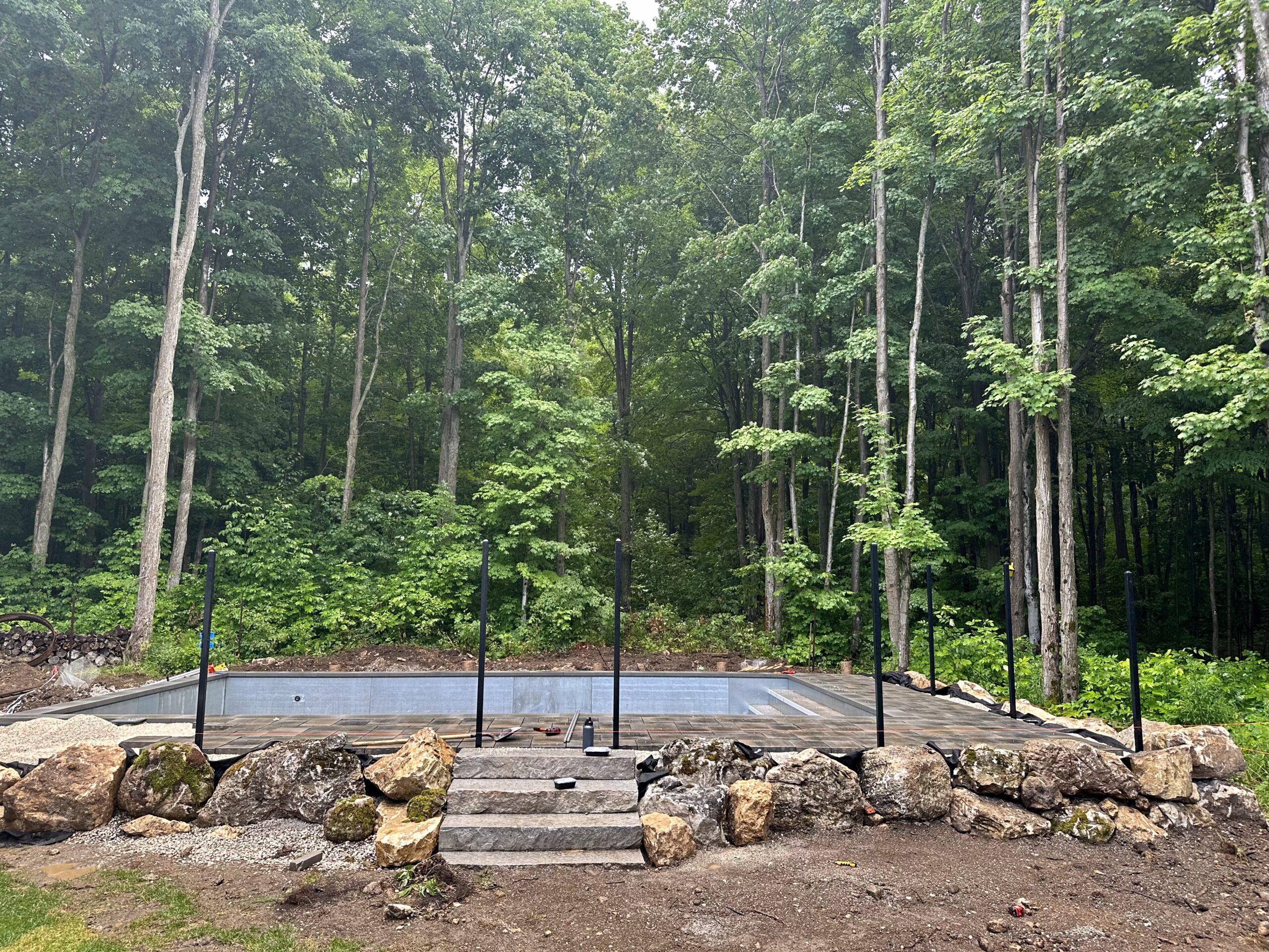 backyard swimming pool under construction