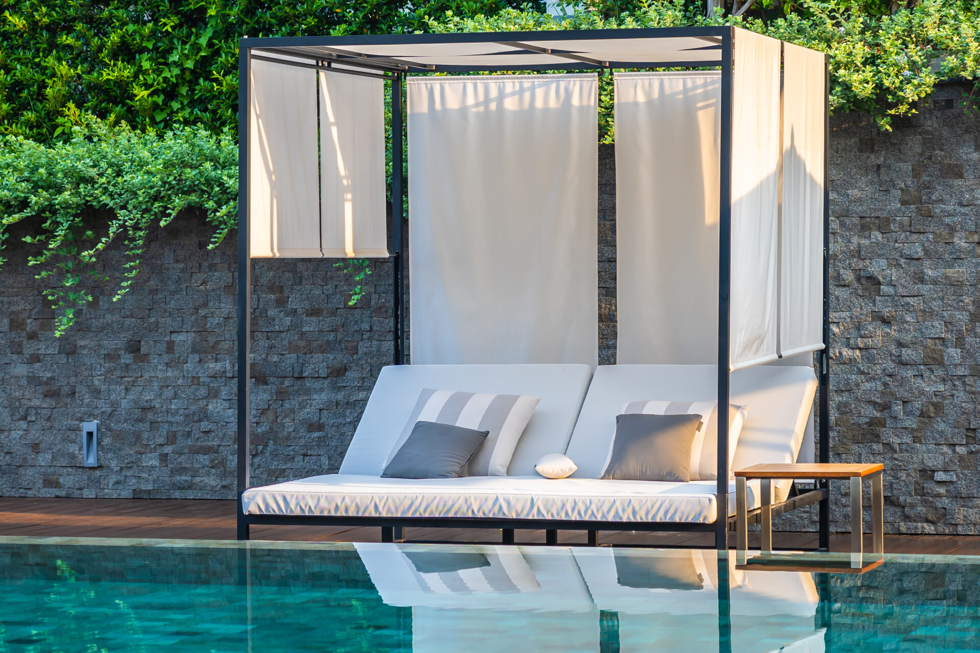 Outdoor swimming pool with umbrella chair lounge around there for leisure travel and vacation concept